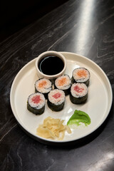 A Beautiful Plate Filled with Delicious Sushi Rolls Accompanied by Soy Sauce for Dipping