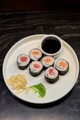 A Beautiful Plate Filled with Delicious Sushi Rolls Accompanied by Soy Sauce for Dipping