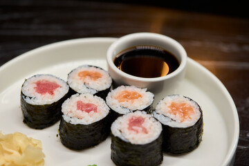 A Beautiful Plate Filled with Delicious Sushi Rolls Accompanied by Soy Sauce for Dipping