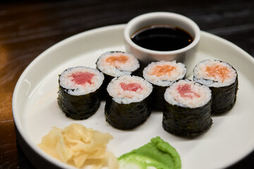A Beautiful Plate Filled with Delicious Sushi Rolls Accompanied by Soy Sauce for Dipping