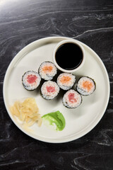 A Beautiful Plate Filled with Delicious Sushi Rolls Accompanied by Soy Sauce for Dipping