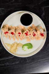 A Beautiful Plate Filled with Delicious Sushi Rolls Accompanied by Soy Sauce for Dipping