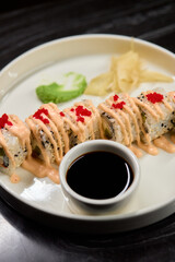 A Beautiful Plate Filled with Delicious Sushi Rolls Accompanied by Soy Sauce for Dipping