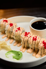 A Beautiful Plate Filled with Delicious Sushi Rolls Accompanied by Soy Sauce for Dipping
