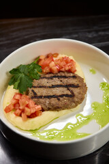 Savor a Grilled Steak served with Tomato Salsa and Green Sauce, beautifully presented