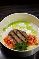 Savor a Grilled Steak served with Tomato Salsa and Green Sauce, beautifully presented