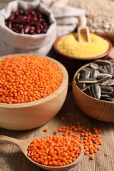 Different types of seeds and legumes on table, closeup