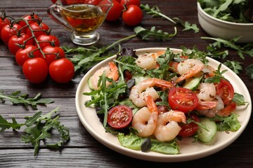 Delicious shrimp salad and ingredients on wooden table, closeup