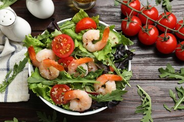 Delicious shrimp salad with vegetables on wooden table, flat lay