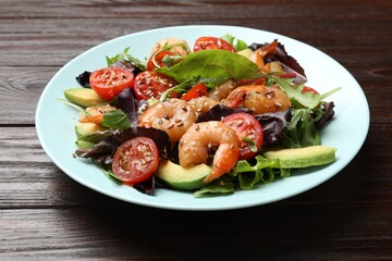 Delicious shrimp salad on wooden table, closeup