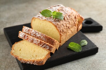 Freshly baked sponge cake on light grey table, closeup