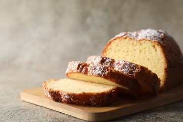 Freshly baked sponge cake on light grey table, closeup