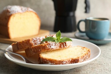 Freshly baked sponge cake and coffee on light grey table, closeup