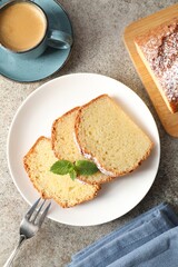 Freshly baked sponge cake and coffee on light grey table, flat lay