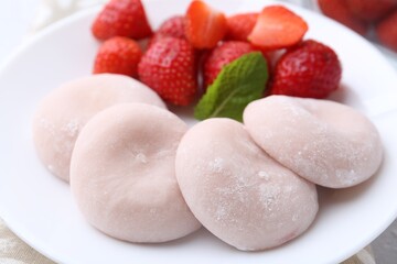 Delicious mochi and strawberries on table, closeup