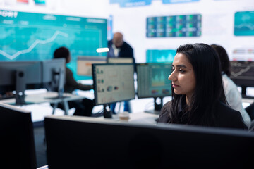 Business administrator examining data for the investors group, reviewing key performance indicators during annual analysis. Manager works on data management, enterprise workflow.