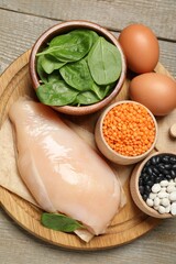 Different products rich in estrogen on wooden table, top view