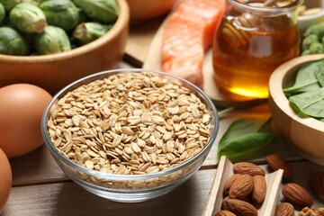 Different products rich in melatonin on wooden table, closeup