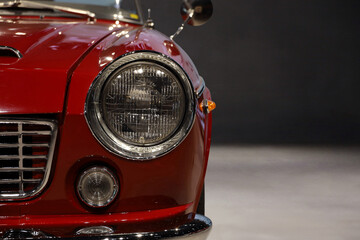 Headlights and front grille of a 60s car