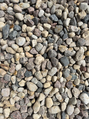 Gravel, granite and pebbles lying on the ground. Granite texture