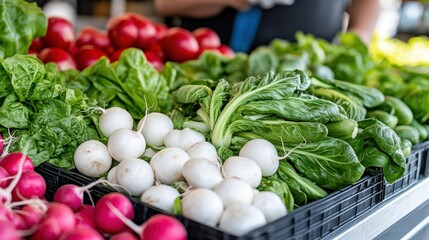A mix of colorful radishes and vibrant greens creatively displayed at a market stand, capturing the energy and diversity of fresh produce selection.