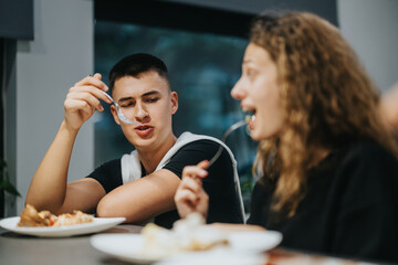 Two students enjoying a meal together, engaging in friendly conversation and laughter in a school cafeteria, capturing the essence of friendship and social connection in an educational setting.