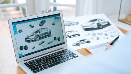 Car design engineer analyze car prototype for automobile business at home office. Automotive engineering designer carefully analyze, finding flaws and improvement for car design with laptop Synchronos
