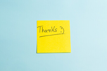 A yellow sticky note with the word "THANKS" written on it