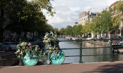 Bicycle covered by decorative garlands on a bridge in Grachtengordel