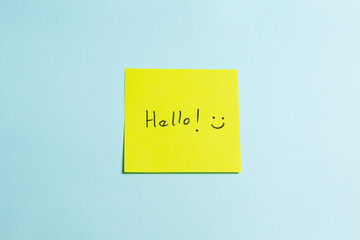 A yellow sticky note with the word "hello" written on it