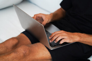 Close-up of hands typing on a laptop keyboard, focusing on the fingers and keys in action