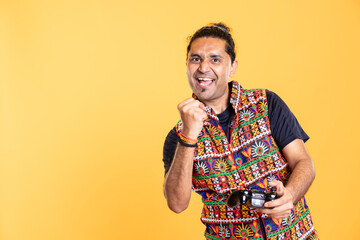 Cheerful gamer clutching fist, celebrating after winning game on gaming console, studio background....