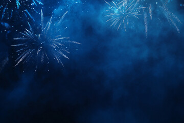 Blue fireworks bursting in the distance with mist and smoke filling the dark sky
