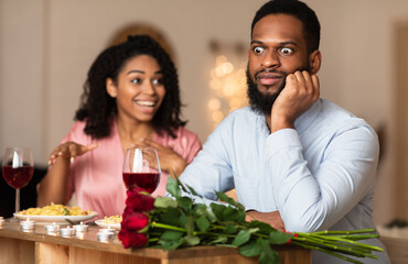 Bad Date. African American Couple Having Unsuccessful Blind Date In Restaurant, Funny Disappointed Shoked Black Man Feeling Embarrassment Listening To Excited Woman Talking