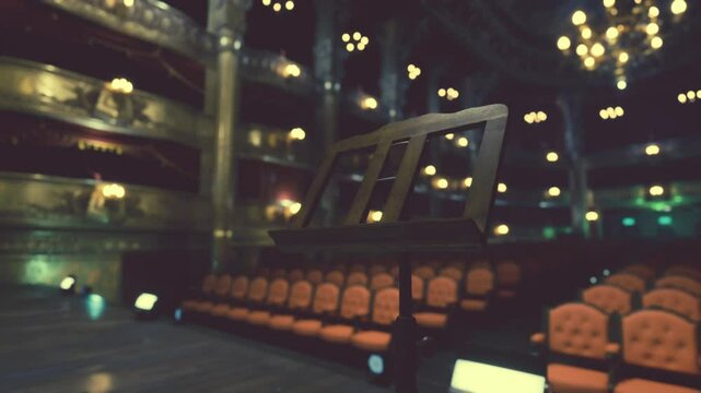 A theater with illuminated rows of seats, ready for a performance to begin.