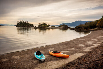 Kayaks on the beach at Ewing Cove, Sucia Island Marine Park, Washington. Emerald waters, forested trails, and sandstone formations have made Sucia Island a crown jewel among our state marine parks.