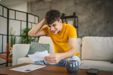 adult young man worried exhausted about expensive bills at home