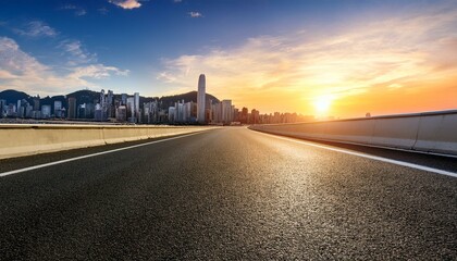 asphalt highway road and mountain with city skyline at sunset