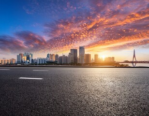 asphalt road and city skyline with colorful sky clouds at sunset