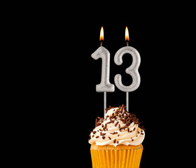 Number 13 shaped candles - Birthday cupcake on black background.