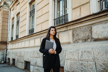 Young businesswoman going to work with laptop in the morning	