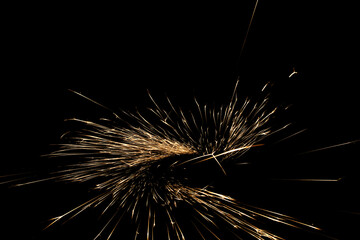 sparks from the grinder glowing in the dark