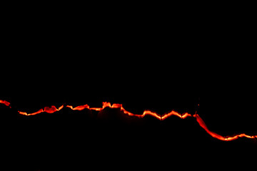 burning paper, glowing edge of paper on a black background