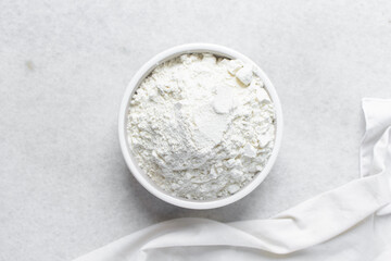 All purpose flour in a ceramic bowl, baking flour in a bowl