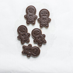 top view of gingerbread man cookie dough, Overhead view of cut out gingerbread molasses cookie dough on a marble countertop, process of making gingerbread christmas cookies