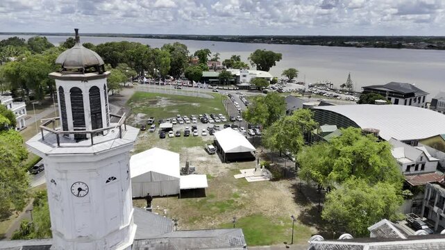 Drone flies over Historical Building of the Ministry of Finance and the town square Onafhankelijkheids plein to Fort Zeelandia in Paramaribo, Suriname