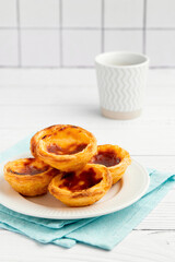 Traditional Portuguese egg tart dessert Pasteis Pastel de nata or Pasteis de Belem with coffee over white background
