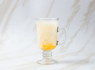 Es Kelapa Jeruk, a typical Indonesian drink made from fresh oranges squeezed with grated young coconut. with copy space. perfect for recipe, article, catalogue, or any commercial purposes.