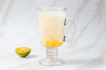 Es Kelapa Jeruk, a typical Indonesian drink made from fresh oranges squeezed with grated young coconut. with copy space. perfect for recipe, article, catalogue, or any commercial purposes.