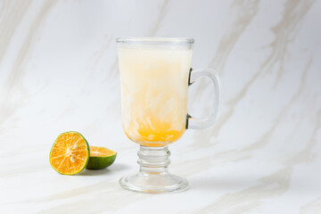 Es Kelapa Jeruk, a typical Indonesian drink made from fresh oranges squeezed with grated young coconut. with copy space. perfect for recipe, article, catalogue, or any commercial purposes.